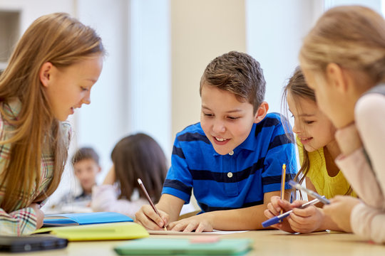 group of students talking and writing at school