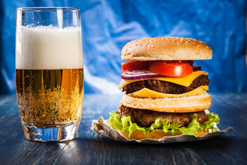 Hamburger on paper with beer