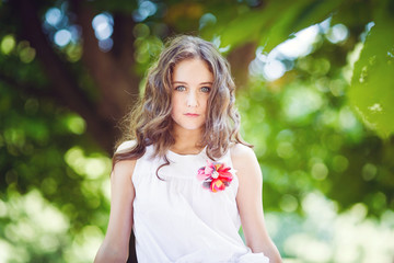 Portrait of young beautiful girl in a park