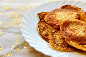 Small pancakes on a white plate. Wide pancake week