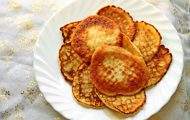 Small pancakes on a white plate. Wide pancake week