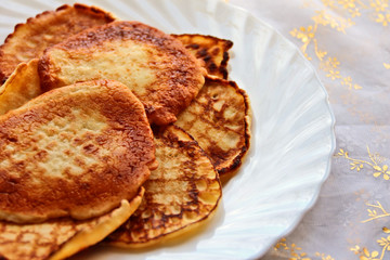 Small pancakes on a white plate. Wide pancake week