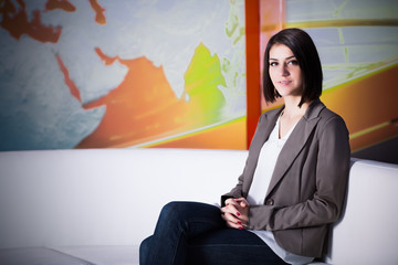 Beautiful television announcer at studio during live broadcast