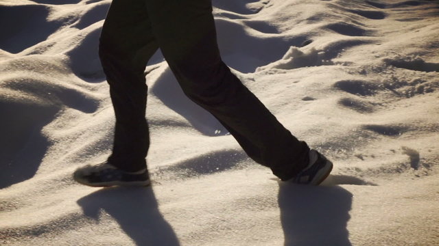 Man running down on the snow, steady, slow motion 240fps