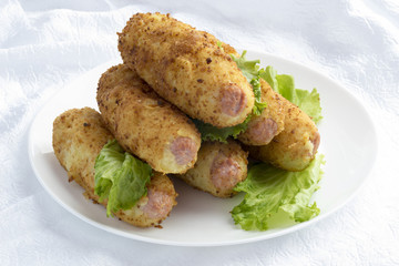 Sausages in mashed potatoes with breadcrumbs.