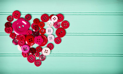 Sewing buttons in the shape of a heart