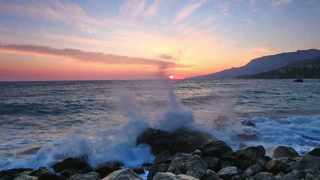 Beautiful landscape with sunrise over the sea and rocks