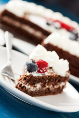Homemade chocolate cake with cream and berries