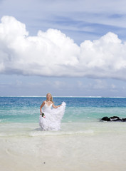 Fototapeta na wymiar woman on edge of the sea on beach. Polynesia...