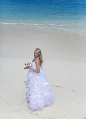 Fototapeta na wymiar beautiful woman on edge of sea on beach. Polynesia...