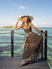 The young beautiful woman  over  the sea