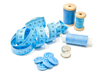 three spools of blue thread, buttons and meter