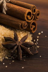 Cinnamon sticks with pure cane brown sugar on wood background