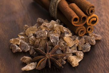 Cinnamon sticks with pure cane brown sugar on wood background