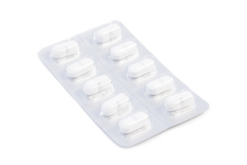 Closeup of white medicine pills in an unused blister pack