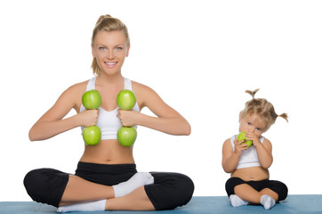 Mom and daughter, fitness dumbbells apples