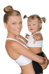 Mother with her daughter in yoga clothes