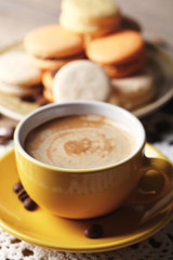 Gentle colorful macaroons and  coffee in mug