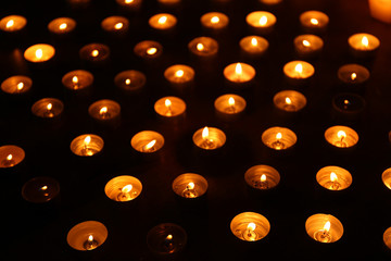 Burning candles on dark background