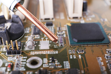 Fototapeta na wymiar Repairing of computer motherboard, macro view