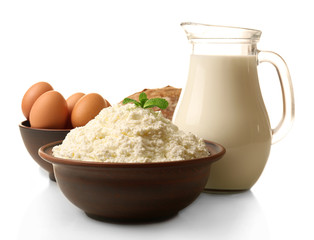 Dairy products in pottery,eggs and glass jug of milk isolated