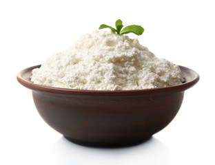 Cottage cheese with mint in clay bowl isolated on white