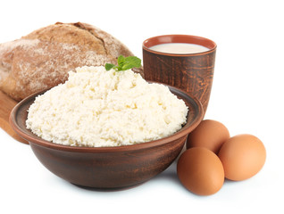 Dairy products with eggs and loaf of bread isolated on white
