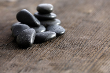 Fototapeta na wymiar Stack of black sea paddles on rustic wooden background