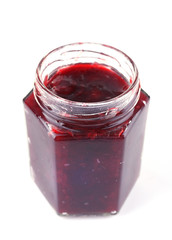 Homemade jar of plum jam isolated on white background