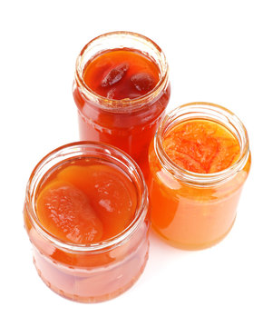 Homemade jars of fruits jam isolated on white background