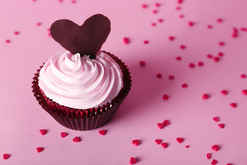 Delicious Valentine Day cupcake on pink background