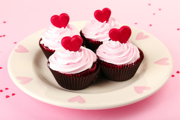 Delicious Valentine Day cupcakes on pink background
