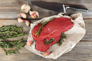 Raw beef steak with rosemary and garlic