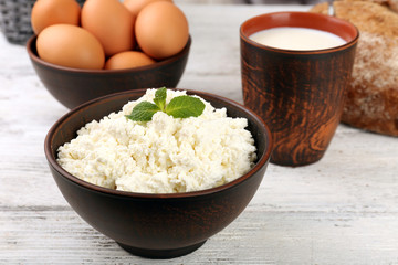 Tasty dairy products with bread on wooden table close up