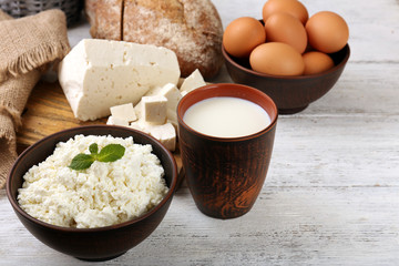 Tasty dairy products with bread on table close up