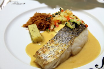 cod fish  fillet with pepper sauce on white plate