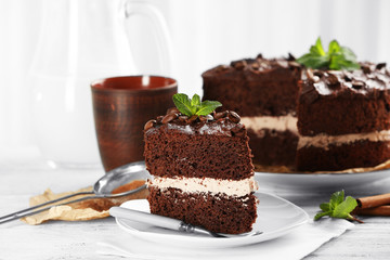 Delicious chocolate cake on table on light background