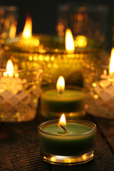 Burning candles in glass candlesticks close-up