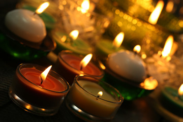 Burning candles in glass candlesticks close-up