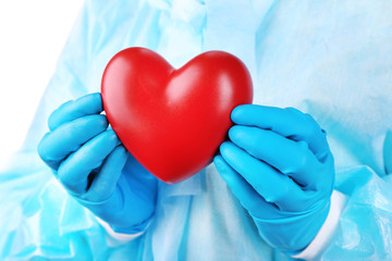 Decorative heart in doctors hands, close-up
