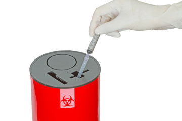 Doctor put syringe in red disposal boxes on white background