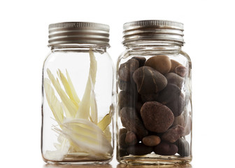 One jar of rocks and one of feathers.