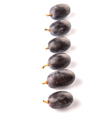 Black grapes over white background