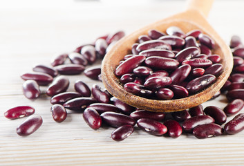 Red beans in  a wooden spoon.