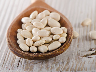 Fototapeta na wymiar White beans in wooden spoon.
