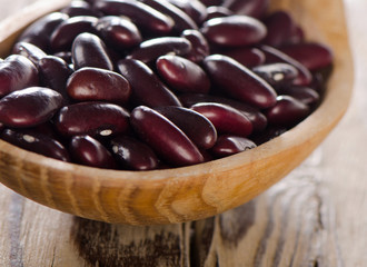 Kidney red beans in  a spoon.