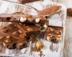 Cocoa Powder and Chocolate bar on  wooden table