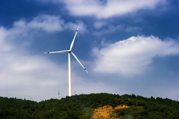 Wind turbine against mountain