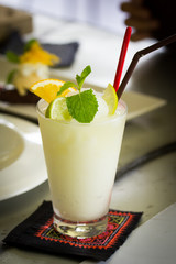 Lemon blend with piece of lemon and mint leaf on glass