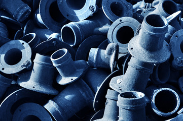 stack of rusted metallic car parts in garage